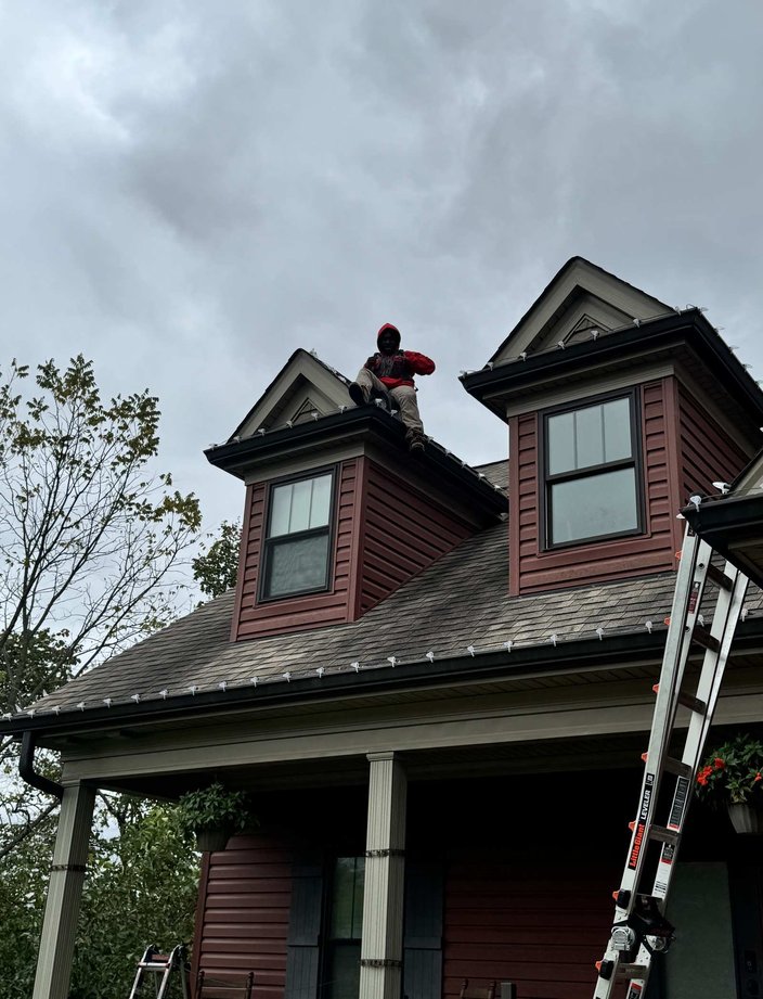 christmas light installer on roof