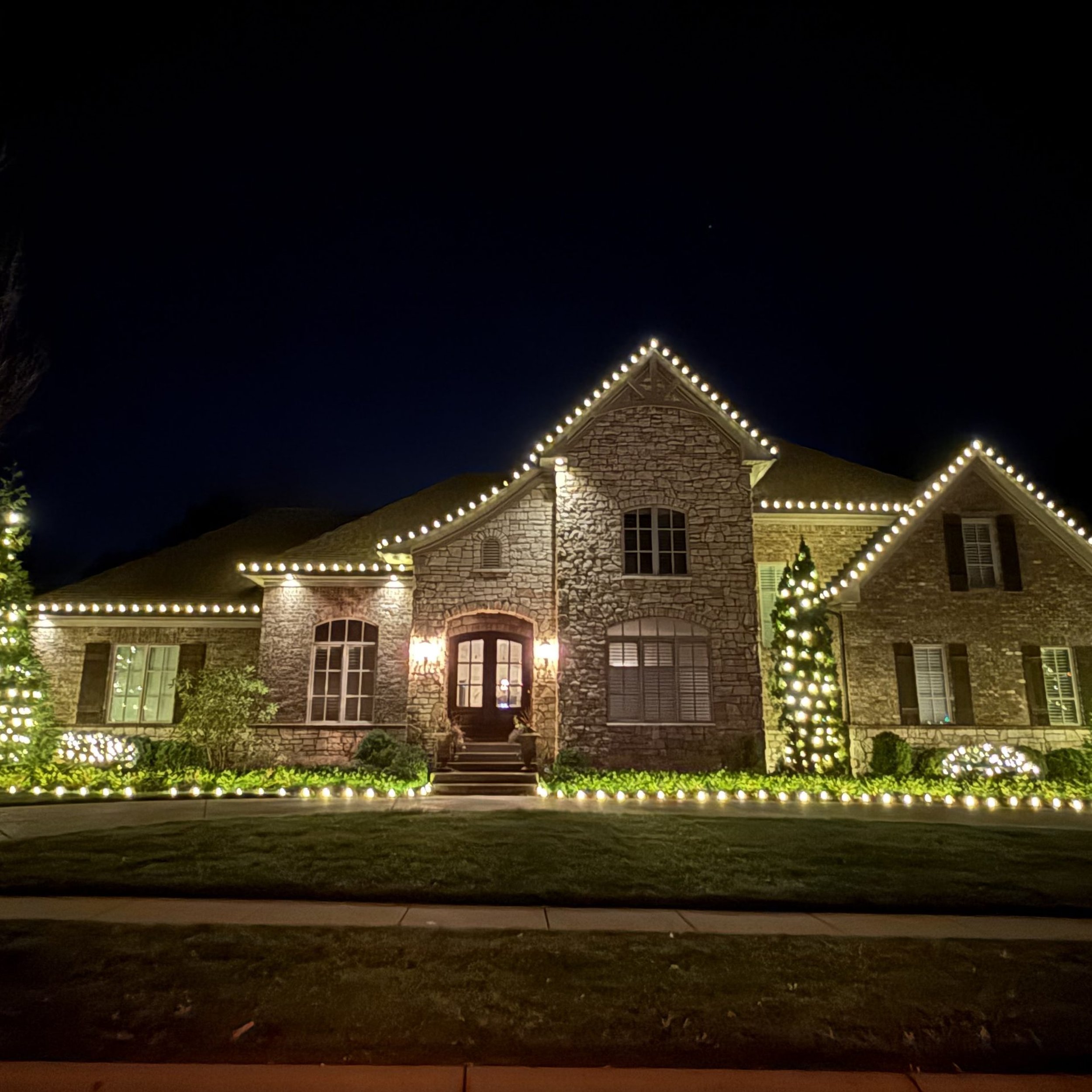 professional Christmas light installation on a stone home in Louisville KY