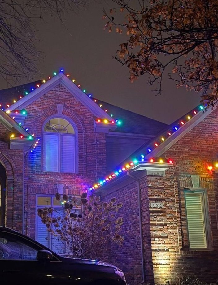 multicolor christmas lights two story brick home
